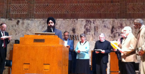 Faith leaders open the press conference with an interfaith prayer representing several faith traditions
