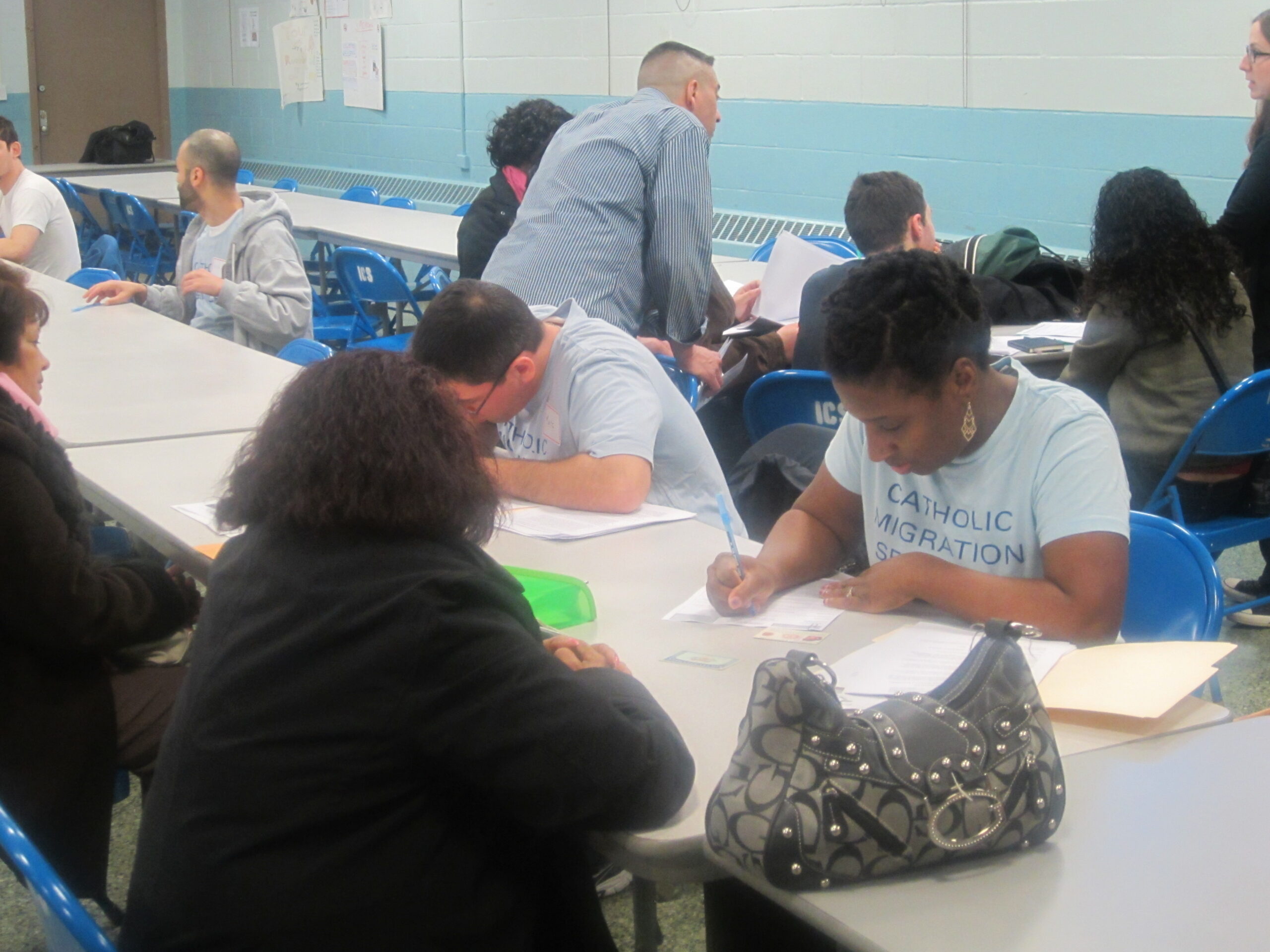 People filing out applications at a workshop