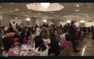 Picture of people in a banquet hall eating