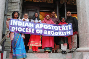 Representatives of Indian Ministry holding a sign