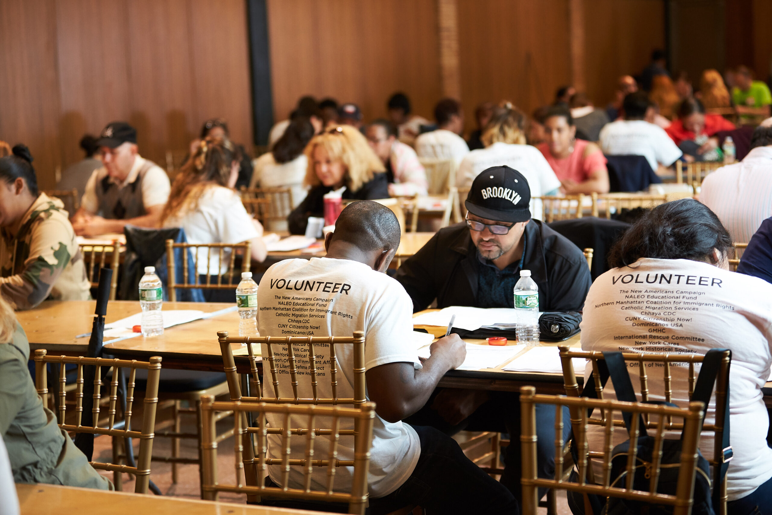 Volunteers at Tables Helping People with Citizenship