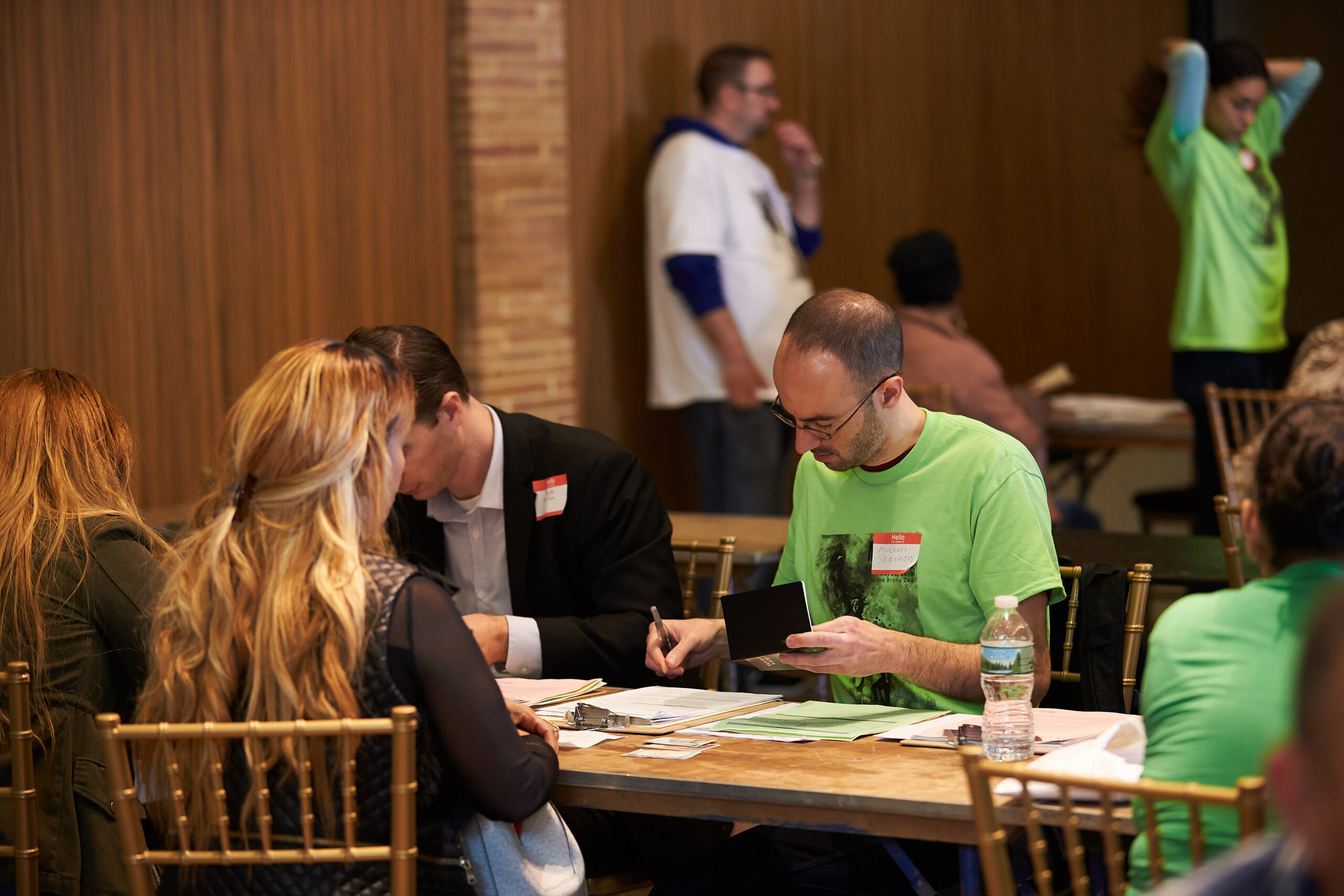 People at Tables Filling out Papers