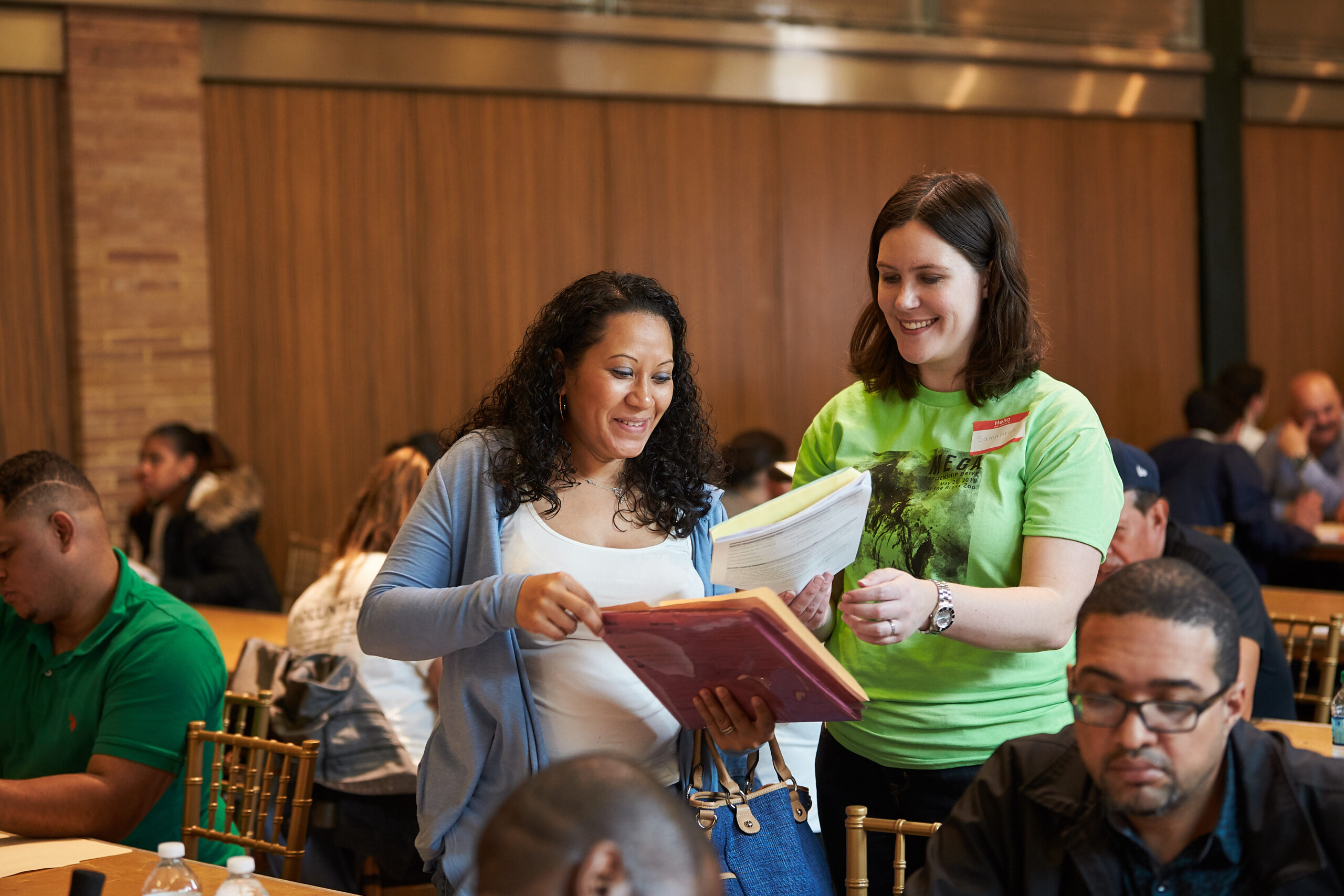 A woman showing another woman papers